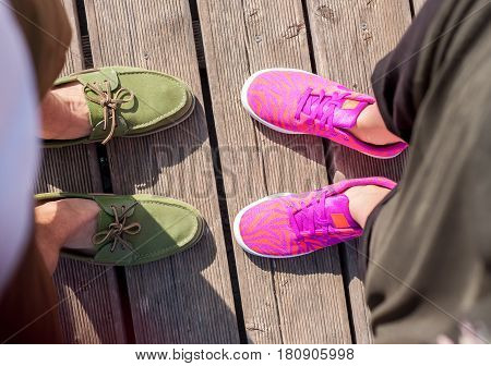 woman and man standing close feet shoes together top view