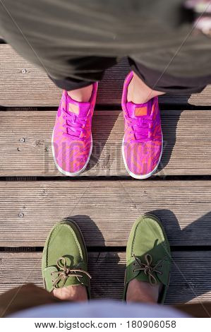woman and man standing close feet shoes together top view