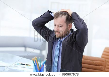 Satisfied businessman relaxing in his modern office