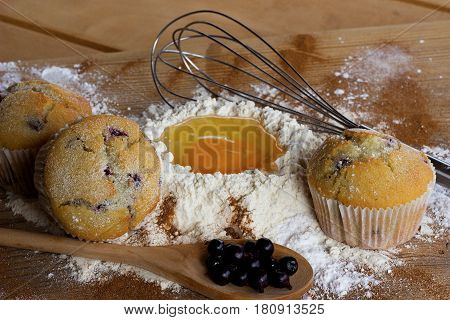 Freshly baked muffins with black currant ingredients and for their preparation