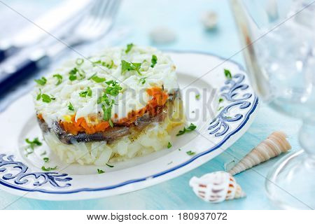 Layered salad with salted fish and boiled vegetables
