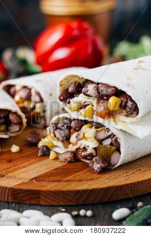 Nice Vegetarian Burrito Over Black Table On Wooden Board.