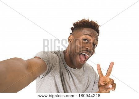 young afro american man smiling happy taking selfie self portrait picture with mobile phone looking excited having fun posing cool isolated in white background in communication technology concept