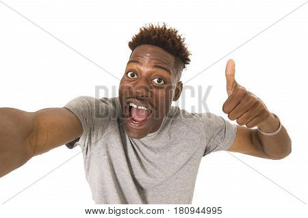 young afro american man smiling happy taking selfie self portrait picture with mobile phone looking excited having fun posing cool isolated in white background in communication technology concept