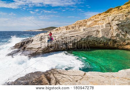 Thassos, Greece - May 2, 2016: People near Giola natural sea water pool located on Thassos island, Greece