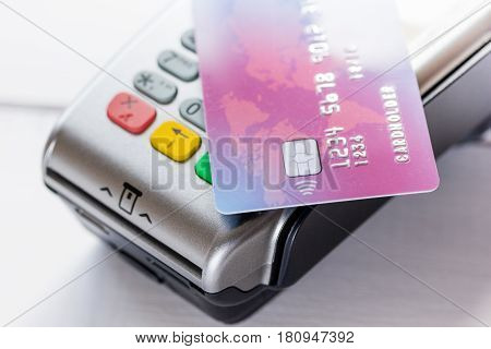 payment terminal and credit card in purchasing concept on stone table background