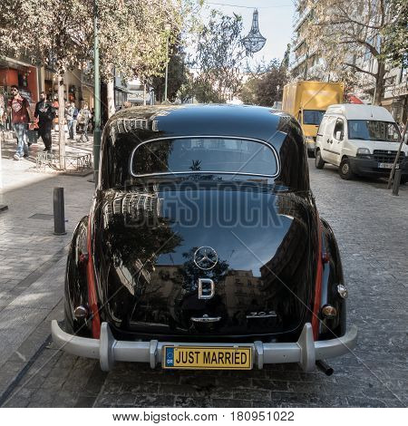 Athens Greece - 23 March 2017: Rear of Black Antique Mercees-Benz 170 S car parked on Ermou Street for use as a wedding limousine. The Mercedes-Benz 170 S was a luxury passenger car manufactured between 1949-1955.