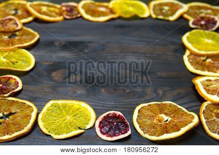 Fruits of dried orange and lemon on a wooden background.