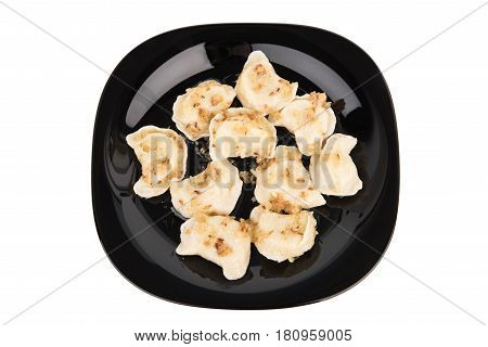 Fresh Dumplings On A Black Plate Seasoned With Crispy Onions. Ukraine