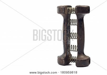 Old cast iron dumbbell carpal expander with springs on white background
