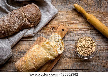 Baking fresh homemade bread on wooden kitchen table background top view moke up