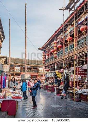 Tianjin, China - Nov 1, 2016: Tianjin Ancient Cultural Street; shop buildings preserved in the classical Qing Dynasty architectural style. Morning scene to what is a very popular tourist area.