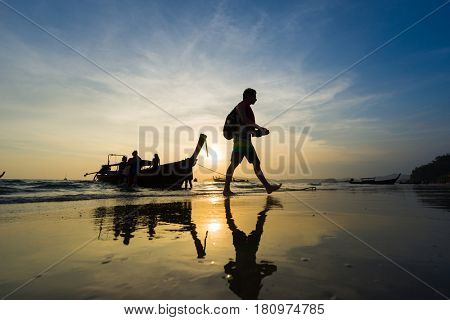 Ao Nang Krabi Thailand - March 03 2017: People on the Ao Nang beach at sunset in Krabi province Thailand