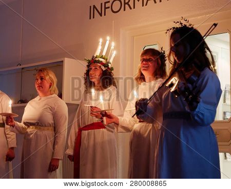 Stockholm, Sweden - Dec 13, 2018: Lucia Parade With Singing Girls In White Dresses Holding Candles. 