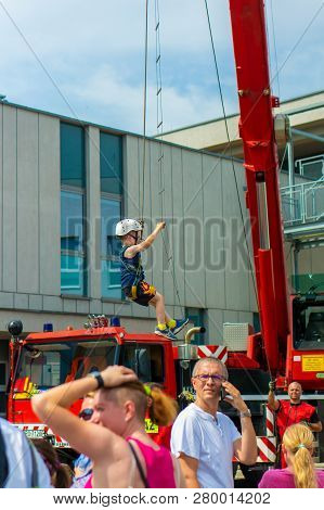 Poznan, Poland - June 9, 2018: Young Boy With Safety Helmet Climbing A Hanging Ladder During The Bez