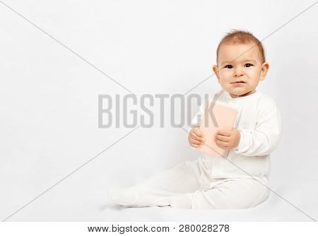 Baby Holding A Mobile Phone Isolated On White Background