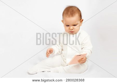 Baby Holding A Mobile Phone Isolated On White Background