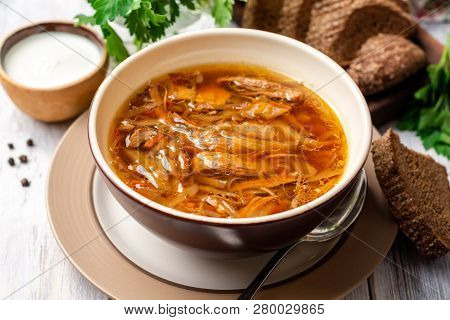 Traditional Russian Sauerkraut Soup Shchi In Bowl On Rustic Wooden Background