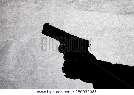 The Gun In The Hand Of Men Who Is Ready To Shoot At His Victim. Breaking The Law And Crime. Attack W