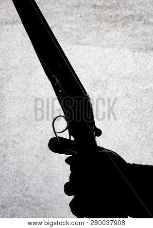 Classic Double-barrell Smooth-bore Hunting Rifle On Man Hand Isolated On Light Stone Background