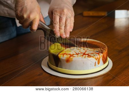 Confectioner Cuts Dacquoise Cake In Mirrored Glaze. Home Cooking. Modern Cooking