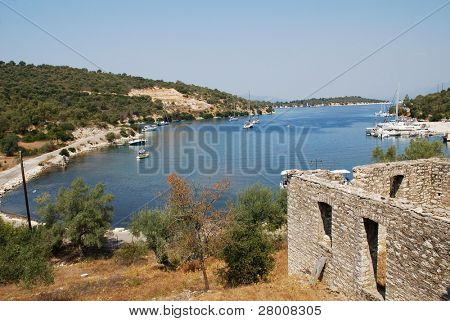 An abandoned stone building stands above Atherinos Bay on the Greek island of Meganissi.