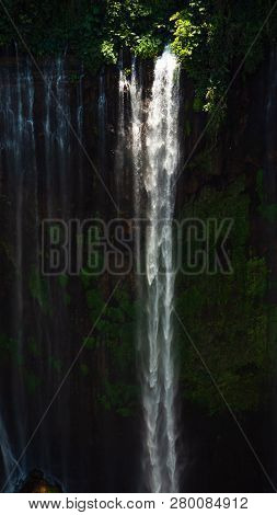 Waterfall Coban Sewu In Java, Indonesia. Waterfall In Tropical Forest By Drone Tumpak Sewu