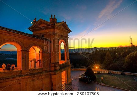 Side View Of Sanctuary Of Blessed Virgin Of San Luca And Colle Della Guardia Above City Of Bologna A