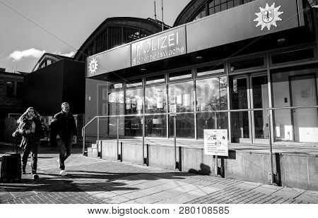 Hamburg, Germany - Mar 20, 2018: Man And Woman Passing By Police Polizei Station Near Hamburg Centra