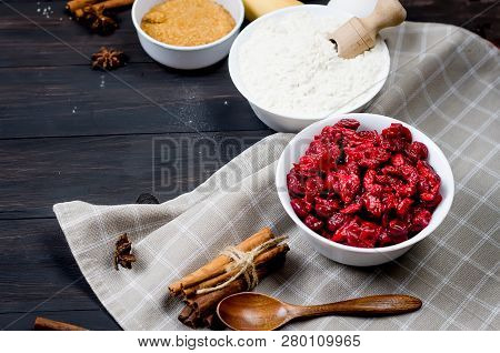 Ingredients For Making Cake  - Flour, Egg, Cherry, Brown Sugar, Cinamon On The Old Wooden Background