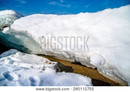 Blocks Of Ice Melt In The Spring On The Shore Of The Pond
