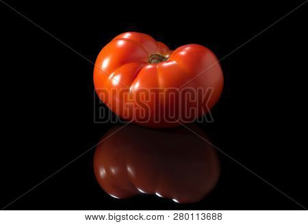 Fresh Tomato Closeup On A Black Background