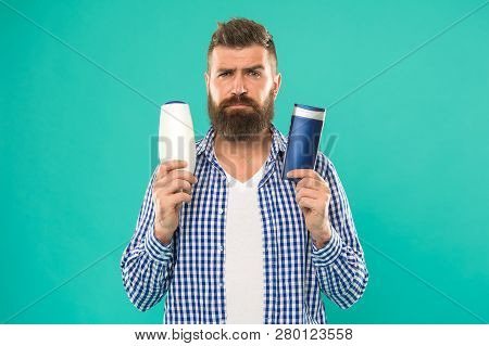 Make Right Choice. Man Bearded Hipster Choose Shampoo Or Shower Gel. Hair Care And Skin Treatment. C