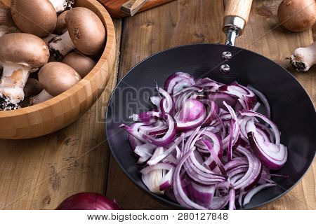 Champignon Mushrooms With Red Onions And Spices On A Wooden Background, Wooden Utensils. Rustic Styl