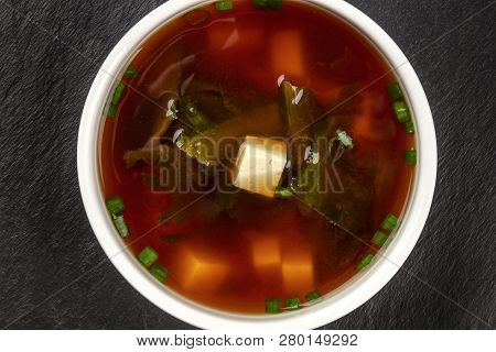 A Closeup Photo Of A Bowl Of Miso Shiru Soup With Tofu, Scallions, And Wakame Seaweed, Shot From Abo