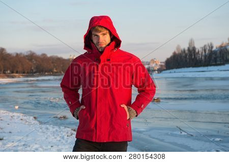 Hipster Winter Warm Outfit. Guy Wear Jacket With Hood On Frosty Winter Day. Man Bearded Stand Warm J