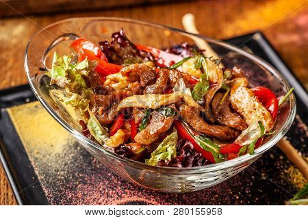The Concept Of Indian Cuisine. Warm Salad With Beef And Chicken, Bell Pepper And Honey Mint Sauce. S