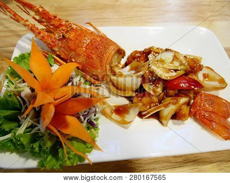 Stir Fried Mini Lobster With Tamarind Xo Sauce Served On Ceramic Dish In Local Restaurant