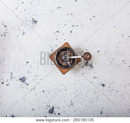 Top View. Traditional Wooden Coffee Mill Grinder On The White Marbled Background.