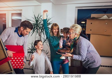 Grandmother And Grandfather Bring A Gift For Moving Into A New Apartment To Their Children