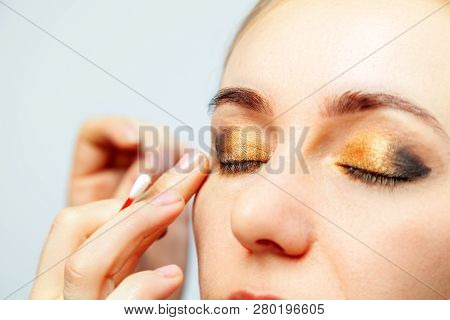 Close-up Of The Make-up Of The Eyes Of A Model With A Light-colored Face, The Make-up Artist Holds A