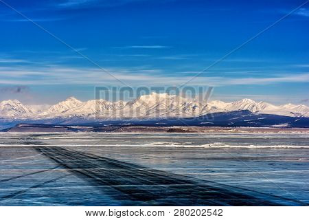 View Of Beautiful Drawings On Ice From Cracks On Surface Of Khubsugul Lake In Winter With Mountain, 