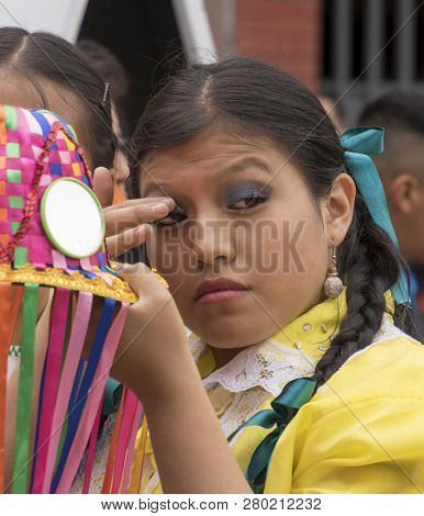 Cuenca, Ecuador - Feb 25, 2017: Young Woman Prepares Her Makeup For The Orquidea Parade In Cuenca, E