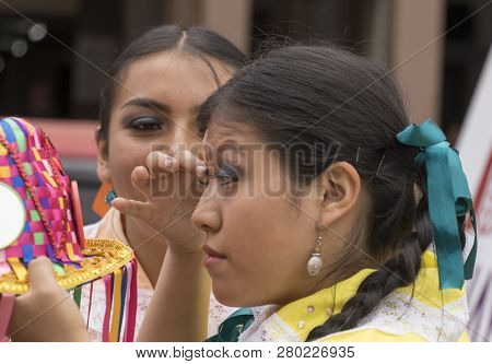 Cuenca, Ecuador - Feb 25, 2017: Young Woman Prepares Her Makeup For The Orquidea Parade In Cuenca, E