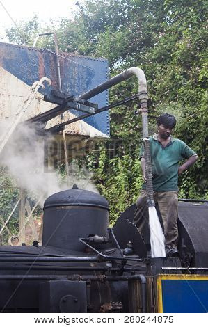Nilgiri, India - August 25: Worker Fill Steam Engine With A Water For A Ride On August 25, 2011 In N