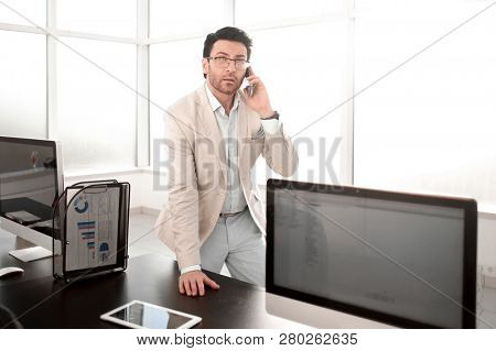 background image of a businessman in a modern office.