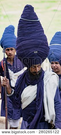 Punjab, India, March 2, 2018: Hola Mohalla Festival - Man Wearing A Very Large Blue Turban To The Ho