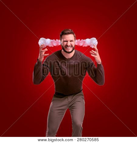 An Angry Man In Casual Outfit Leaning Forward With Steam Coming Out Of His Ears On Red Background.