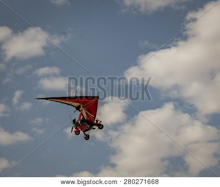 Walvis Bay, Namibia - July 16, 2018: An Ultralight Aircraft Is Seen Flying With Clouds As A Backdrop
