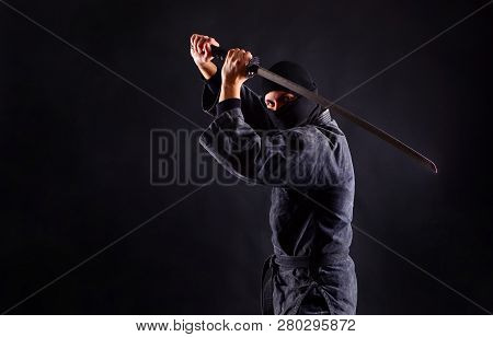 Ninja Warrior With Katana On A Dark Background